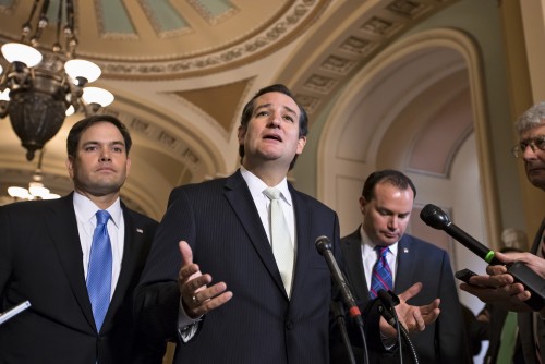 Sen. Ted Cruz, R-Texas, center, accompanied by Sen. Marco Rubio, R-Fla., left, and Sen. Mike Lee, R-Utah, right, express their frustration after the Senate passed a bill to fund the government, but stripped it of the defund "Obamacare" language as crafted by House Republicans, Friday, Sept. 27, 2013, on Capitol Hill in Washington. The Republican-controlled House and the Democrat-controlled Senate are at an impasse as Congress continues to struggle over how to prevent a possible shutdown of the federal government when it runs out of money in three days.  (AP Photo/J. Scott Applewhite)